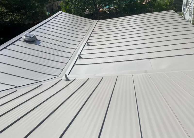 Solar attic fan installed on a metal roof for Roof Ventilation in Bend